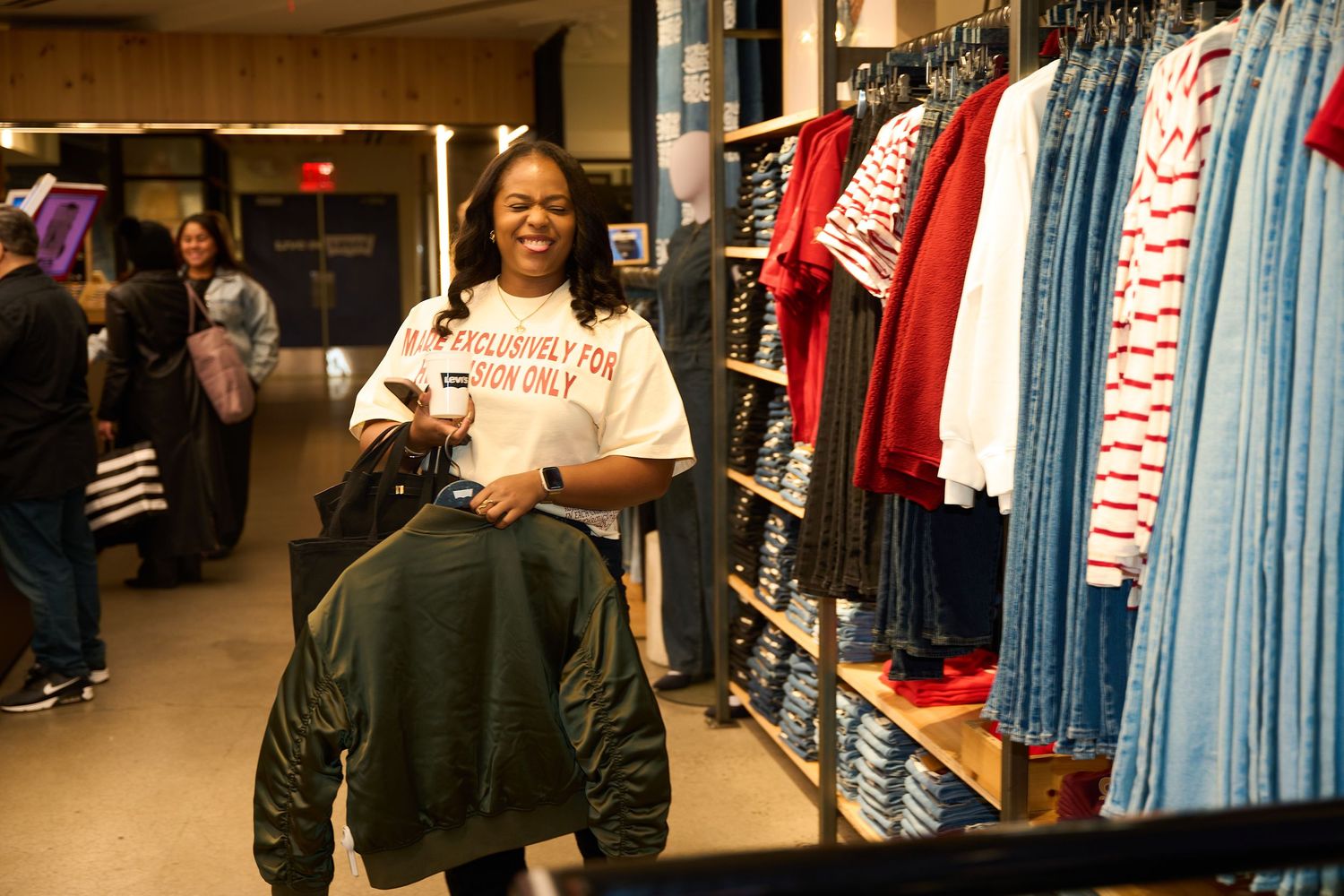 Baseball jerseys and sports apparel displayed on racks in a retail store with team merchandise and clothing.