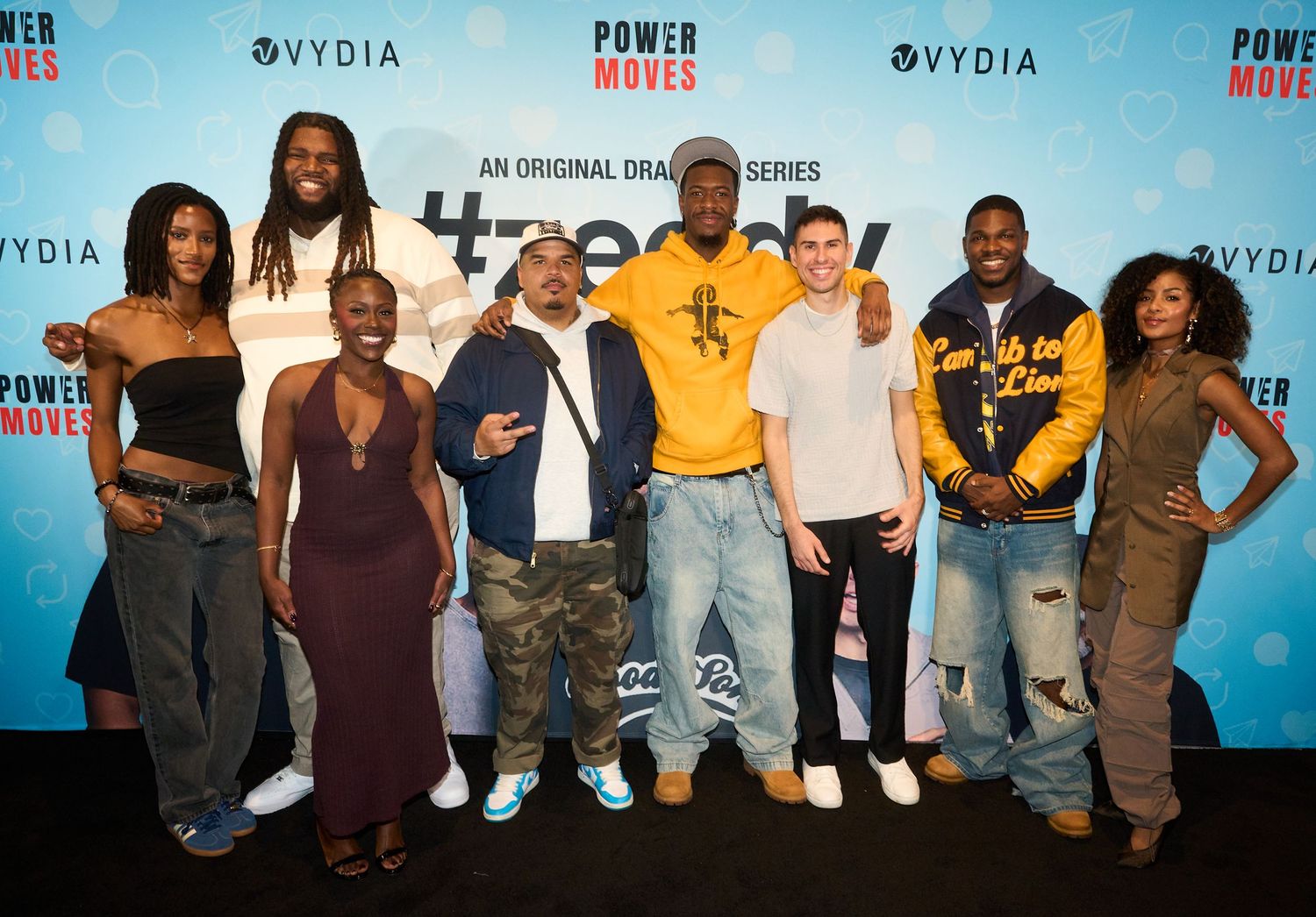 Cast members pose together at the Power Moves original drama series premiere event with Vydia branding backdrop.