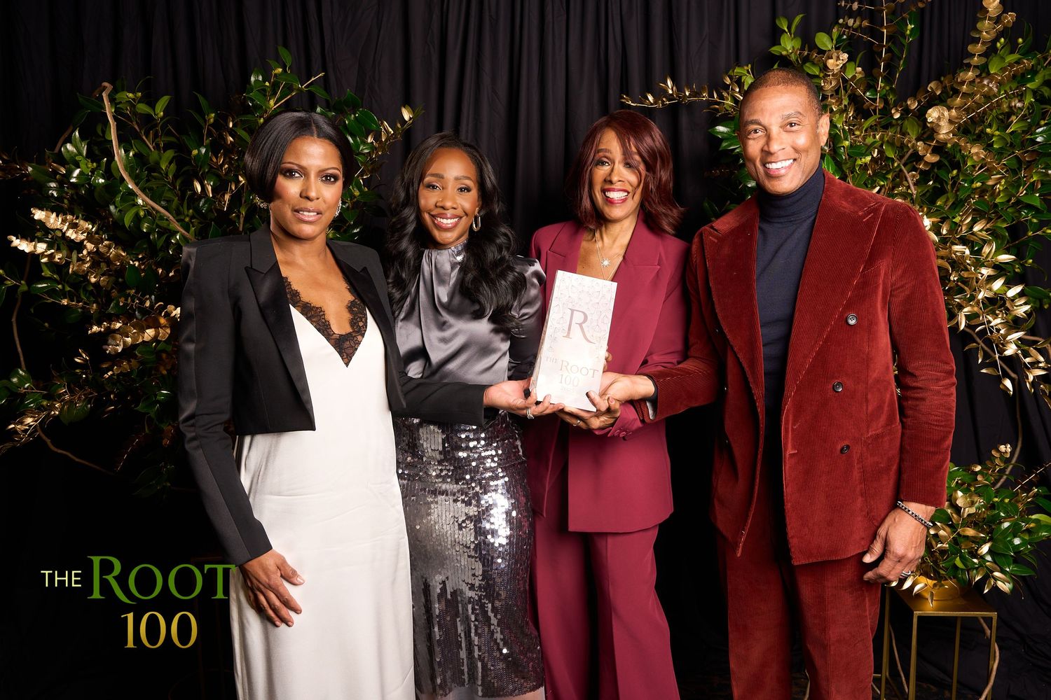 A group of people pose together at a formal event wearing elegant burgundy and white attire.