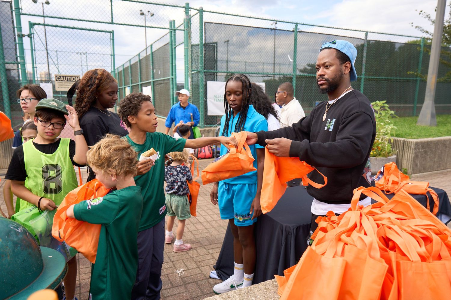 Students participate in outdoor team building activities with colorful orange and green flags and equipment.