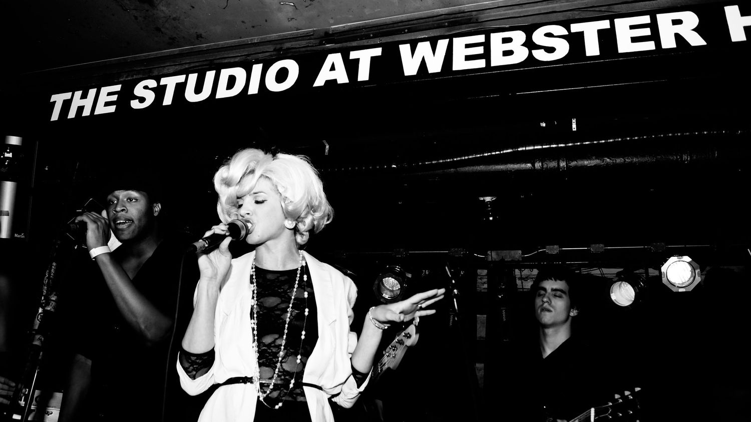 A marquee sign for The Studio at Webster Hall illuminated at night against a dark background.