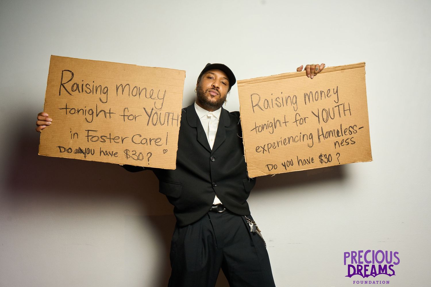 A series of candid photos showing a person in business attire holding various cardboard signs with handwritten messages.