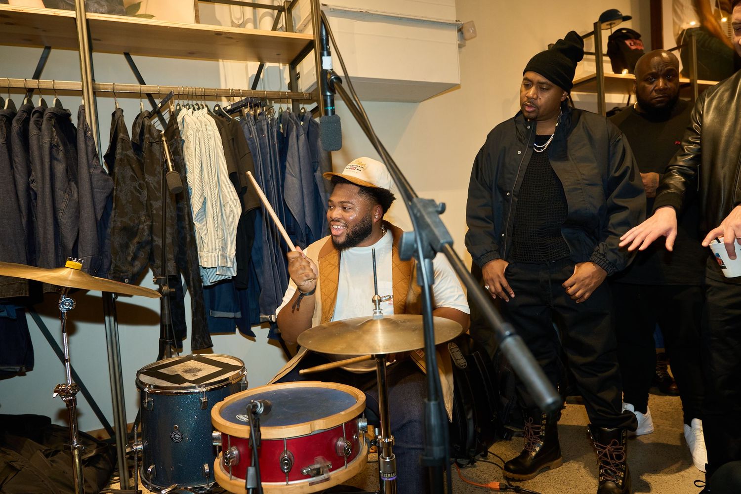 Musicians playing jazz instruments in a basement or studio setting with casual attire.