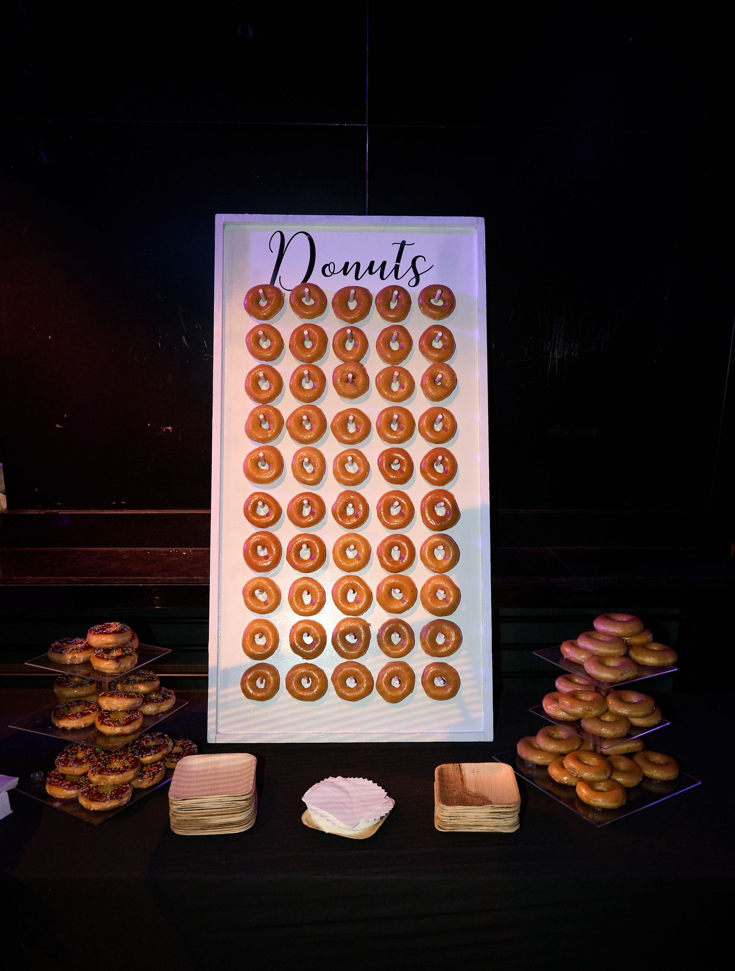 Sequence of photos showing a donut wall display board with multiple rows of glazed donuts arranged in a grid pattern.