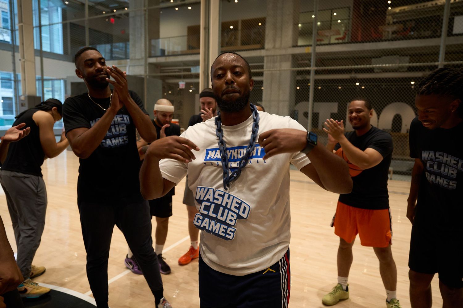 Athletes performing training exercises during an indoor basketball workout session in a modern gym facility.