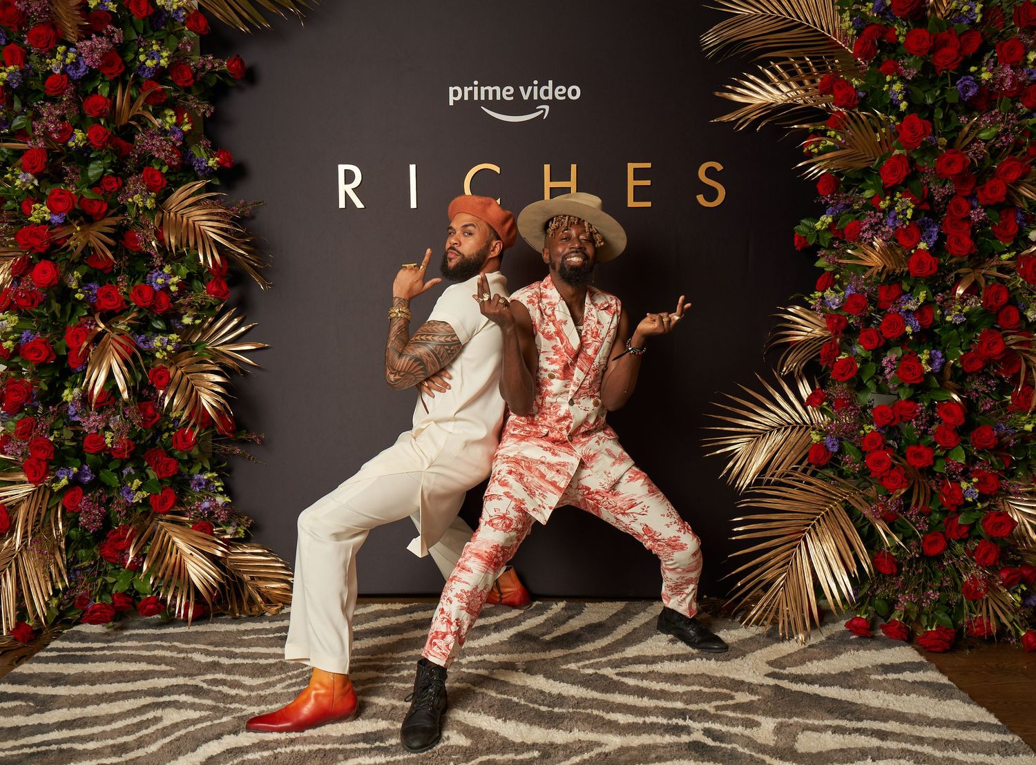 Dancing figures move gracefully across a black and white patterned floor surrounded by red floral arrangements.