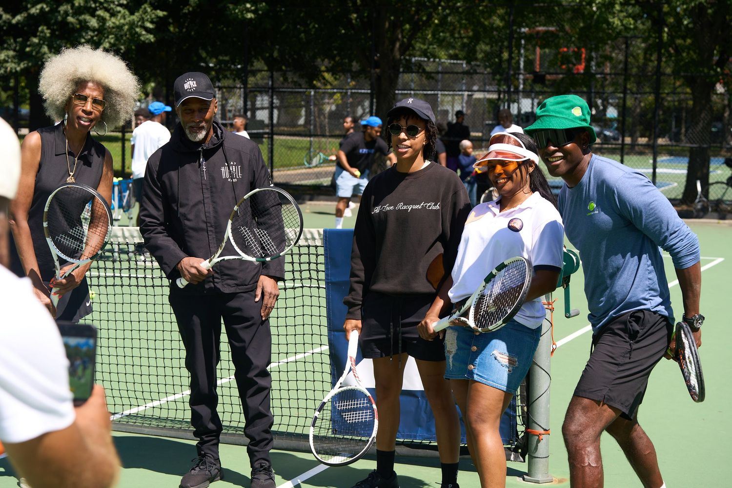 Group of tennis players participating in outdoor drills and practice exercises.