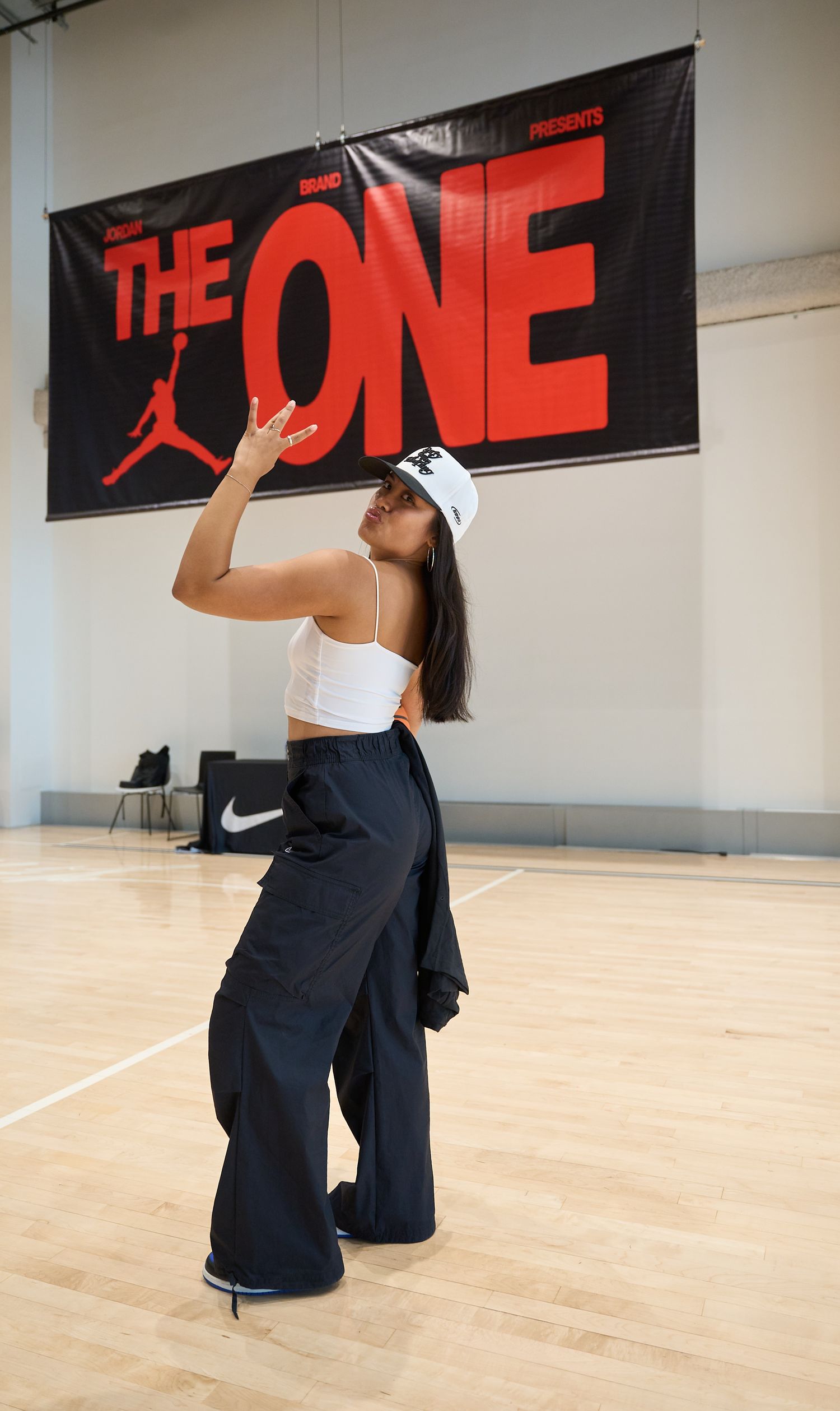 Dancer performing a series of dynamic backward bending movements on a studio floor with red wall banners.