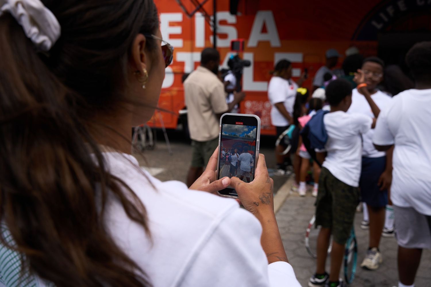Students gathered outside a brick building with EISA signage visible.