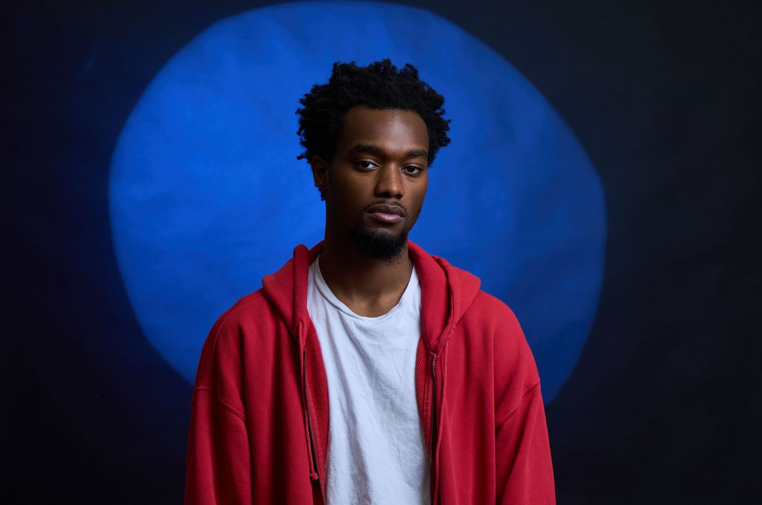A person in a red hoodie and white t-shirt shown in a sequence of poses against a deep blue background.