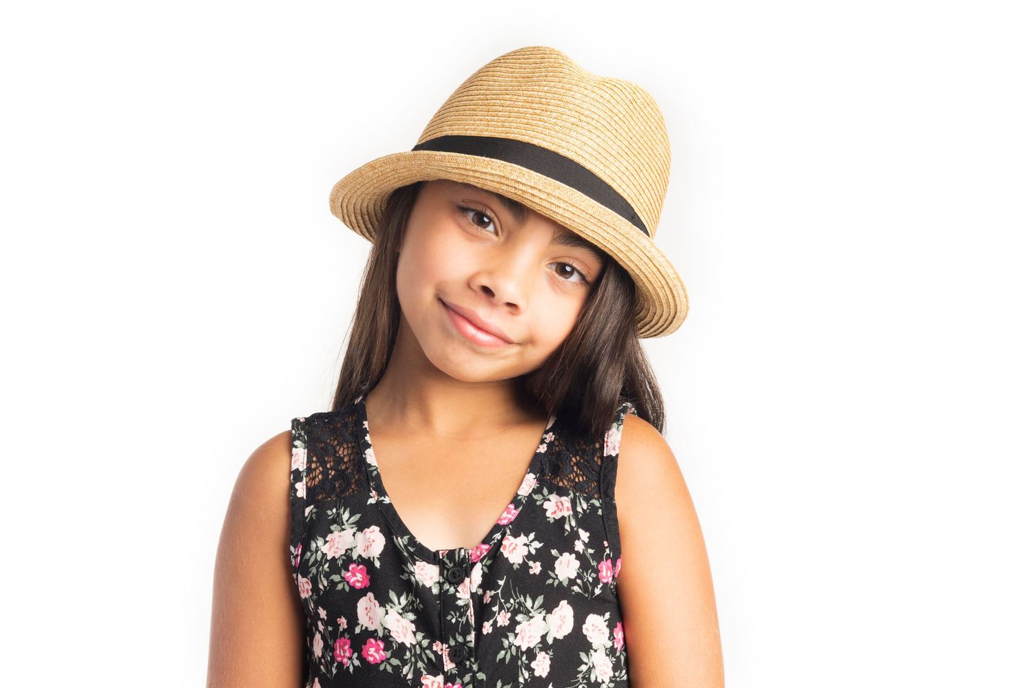 A person wearing a tan fedora and floral print sleeveless top poses against a white background.