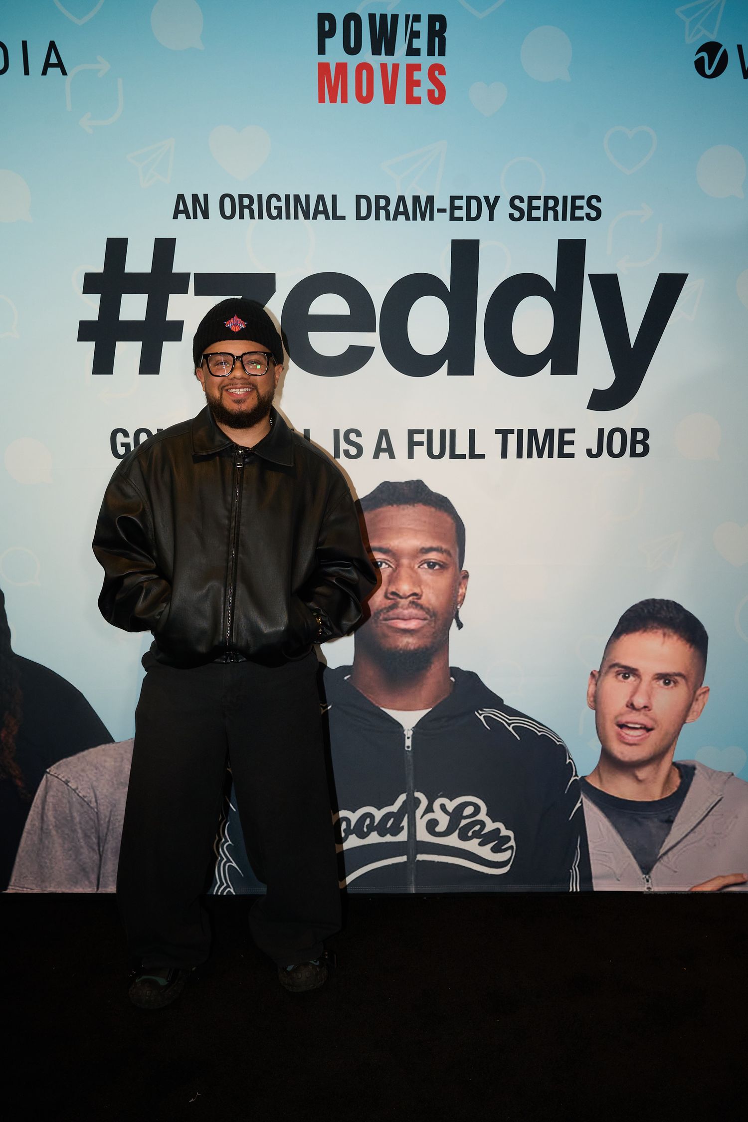 Man posing in front of #Zeddy original dram-edy series promotional banner at Power Moves media event.