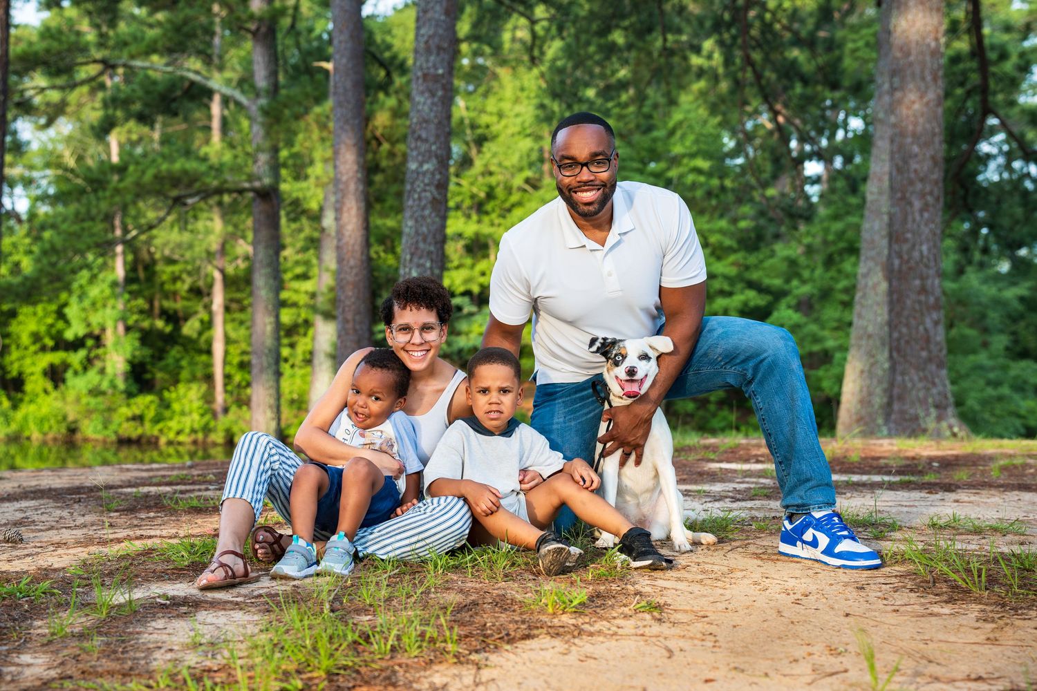 white mix breed rescue dog posing with family at the park in Perry, GA