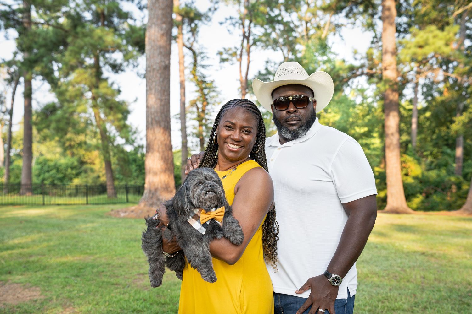 Small dog posing for a pet photoshoot with their dog mom and dog dad at a local park in Georgia.