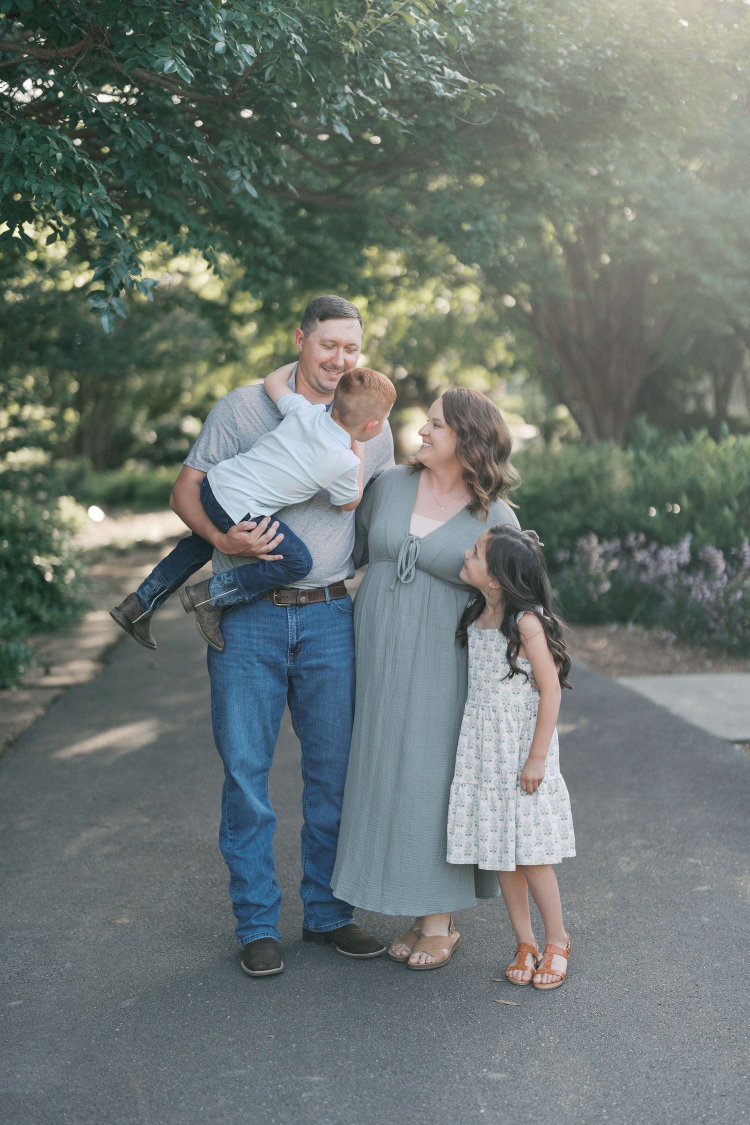 Family portraits outdoors showing playful interactions in a garden setting.