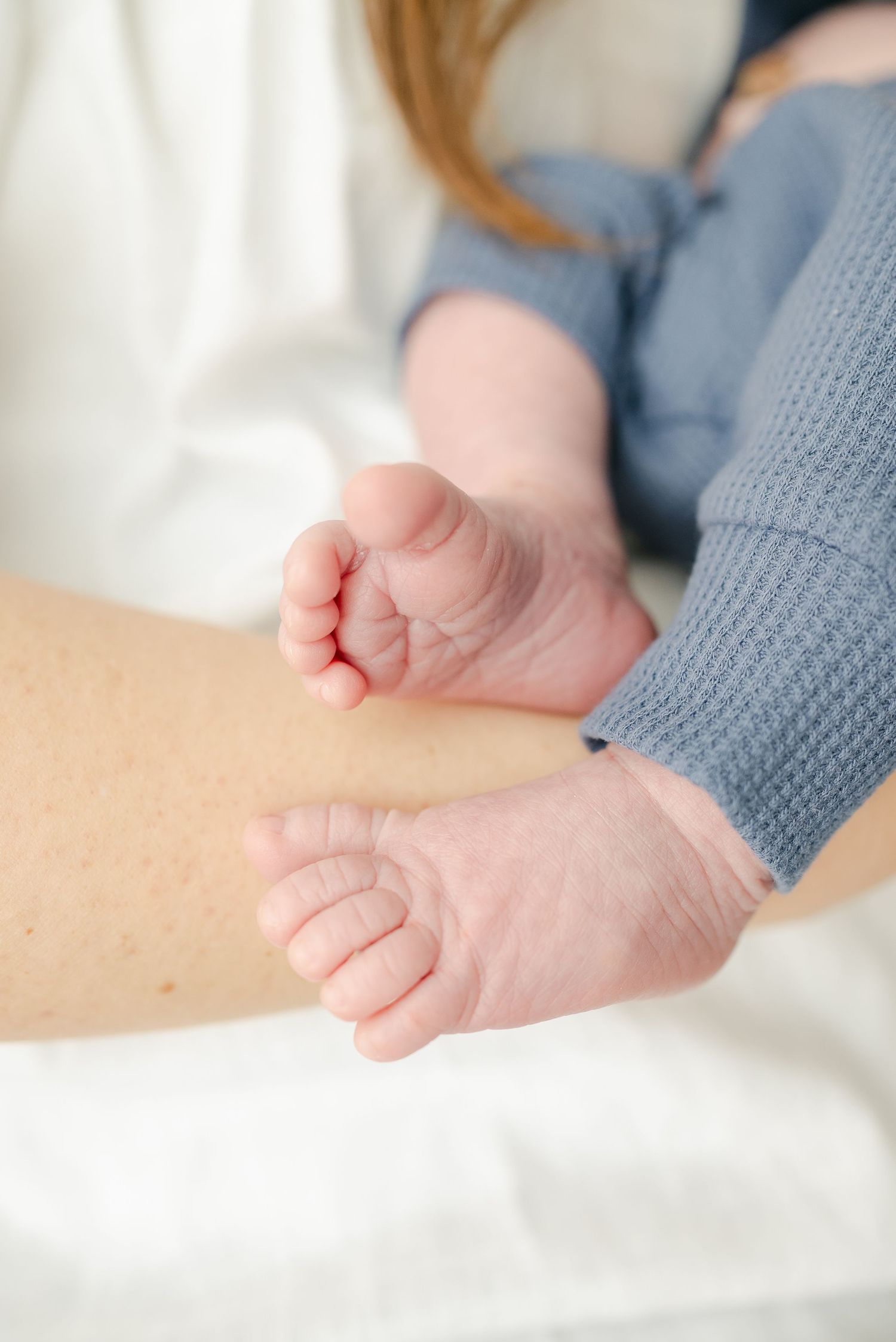 Series of close-up shots showing baby's tiny feet against white background.