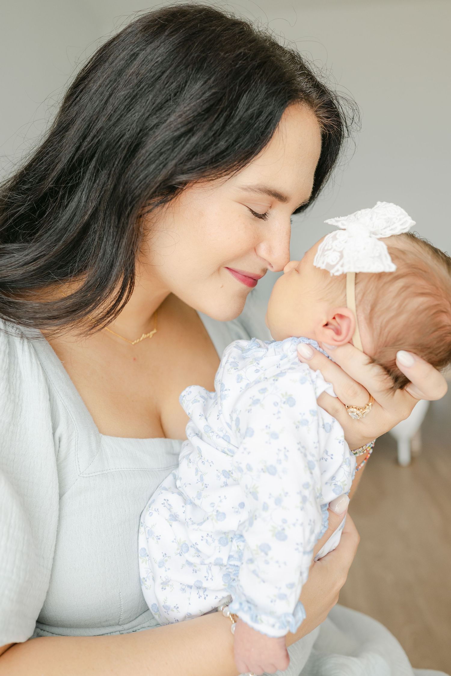 Tender moments between parent and newborn in soft natural light.