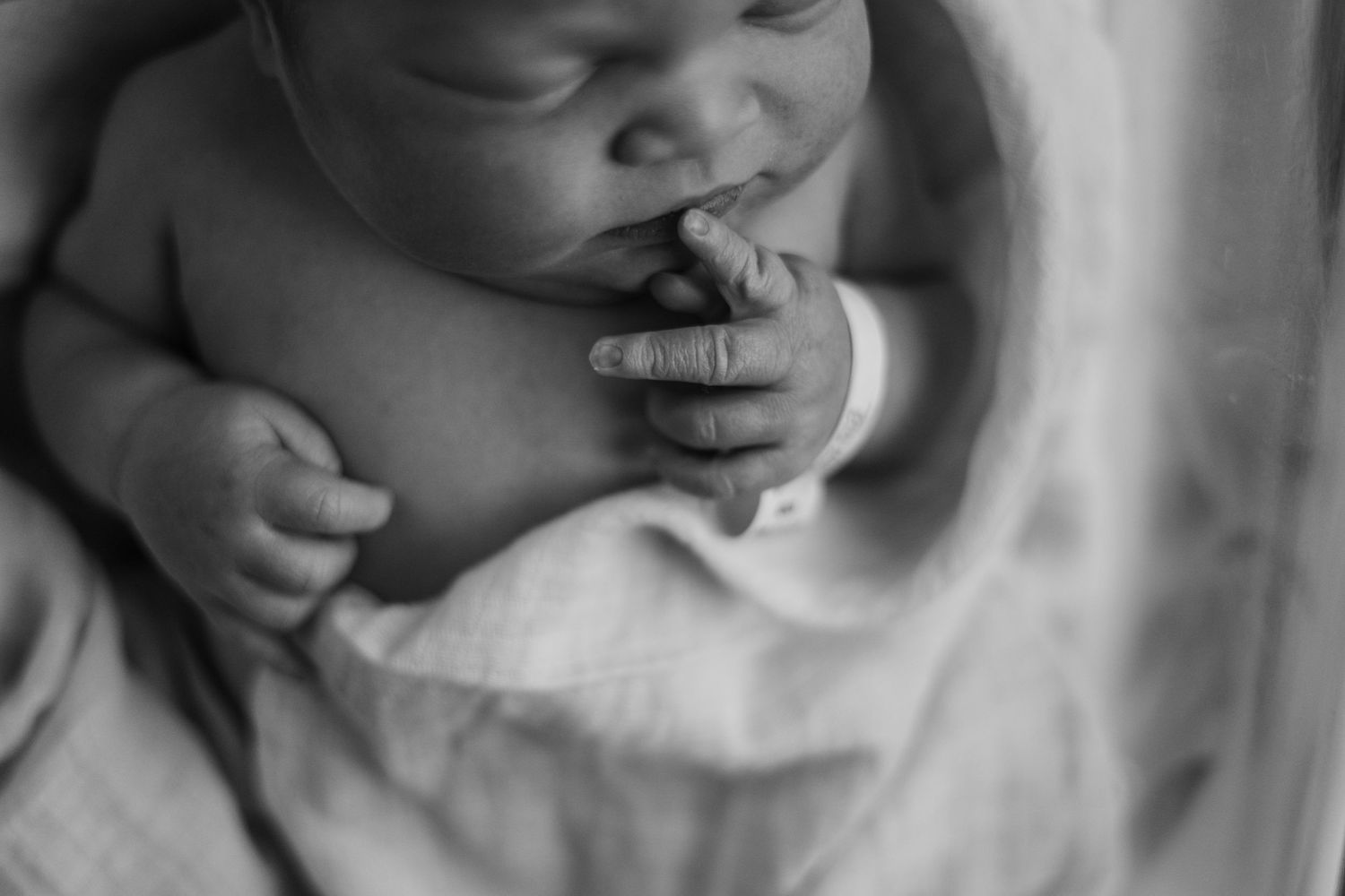 A series of black and white close-up photographs showing tender moments between parent and child.