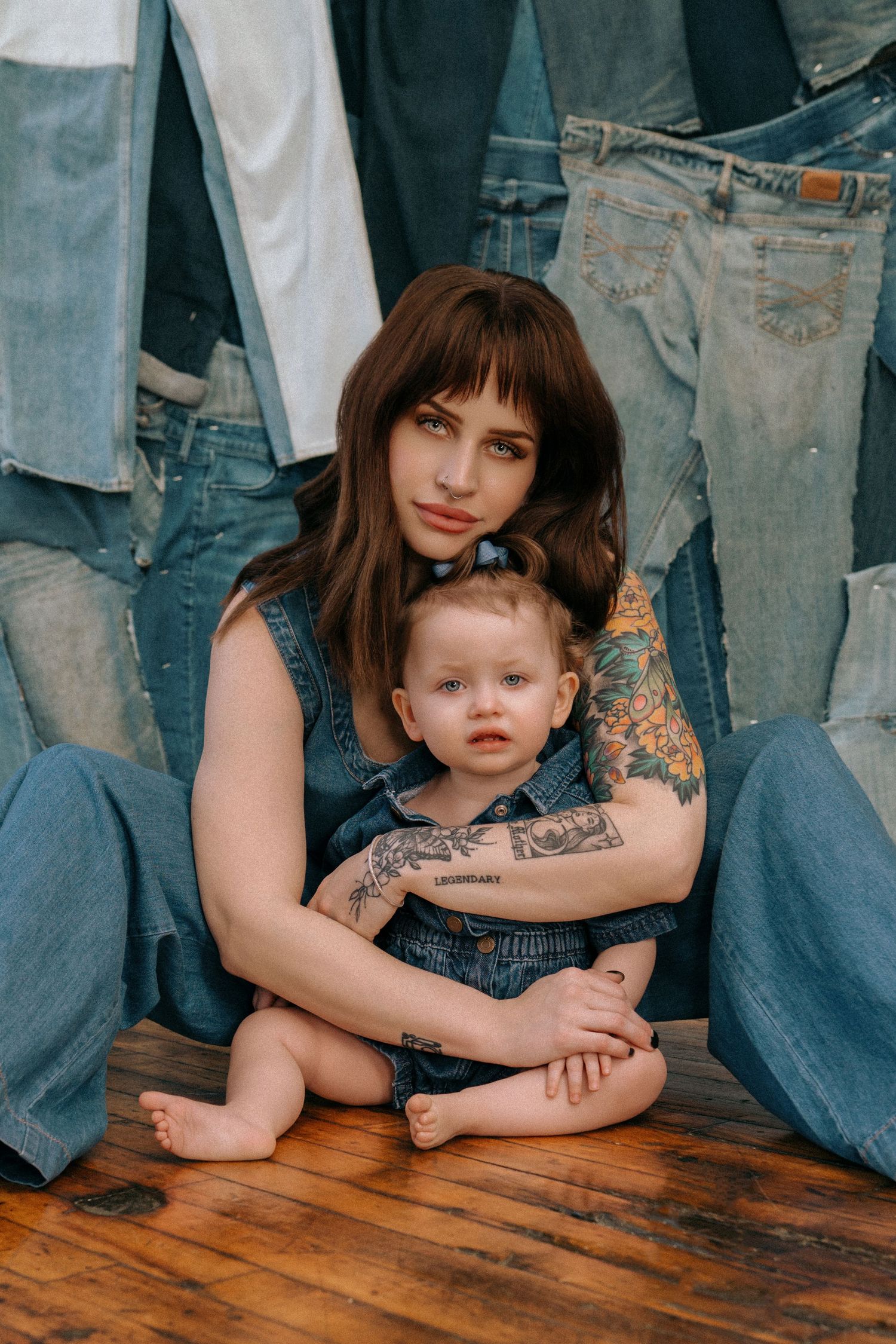 A series of four cropped photos showing a parent and child in denim sitting on a wooden floor.