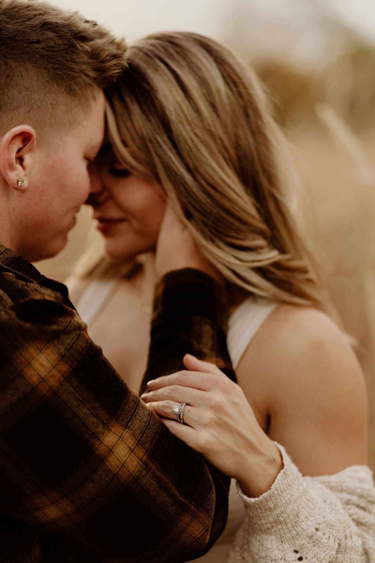A romantic couple shares an intimate moment in warm sepia tones wearing casual attire.