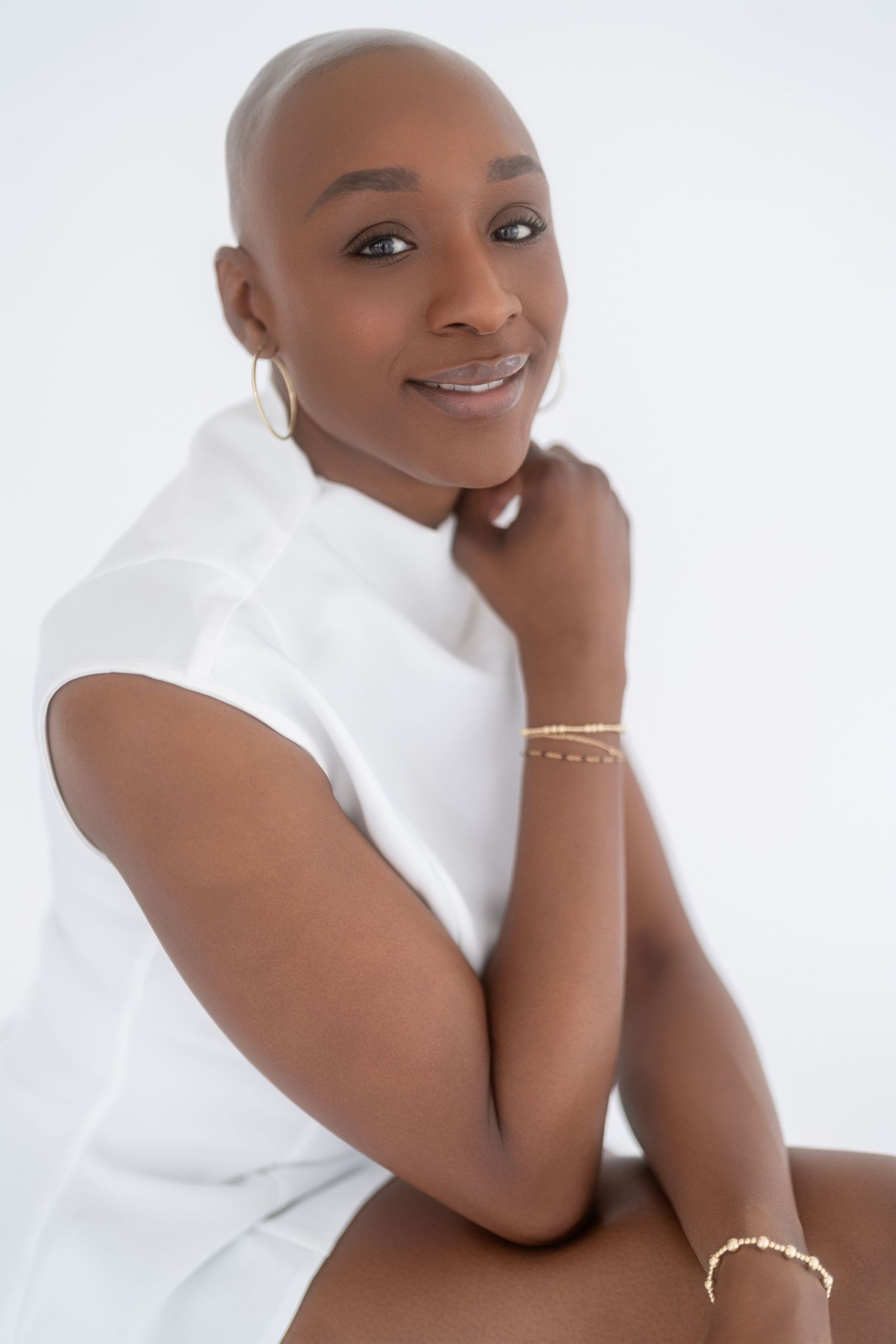 Portrait series of a person wearing a white top against a light background, showing different poses and expressions.