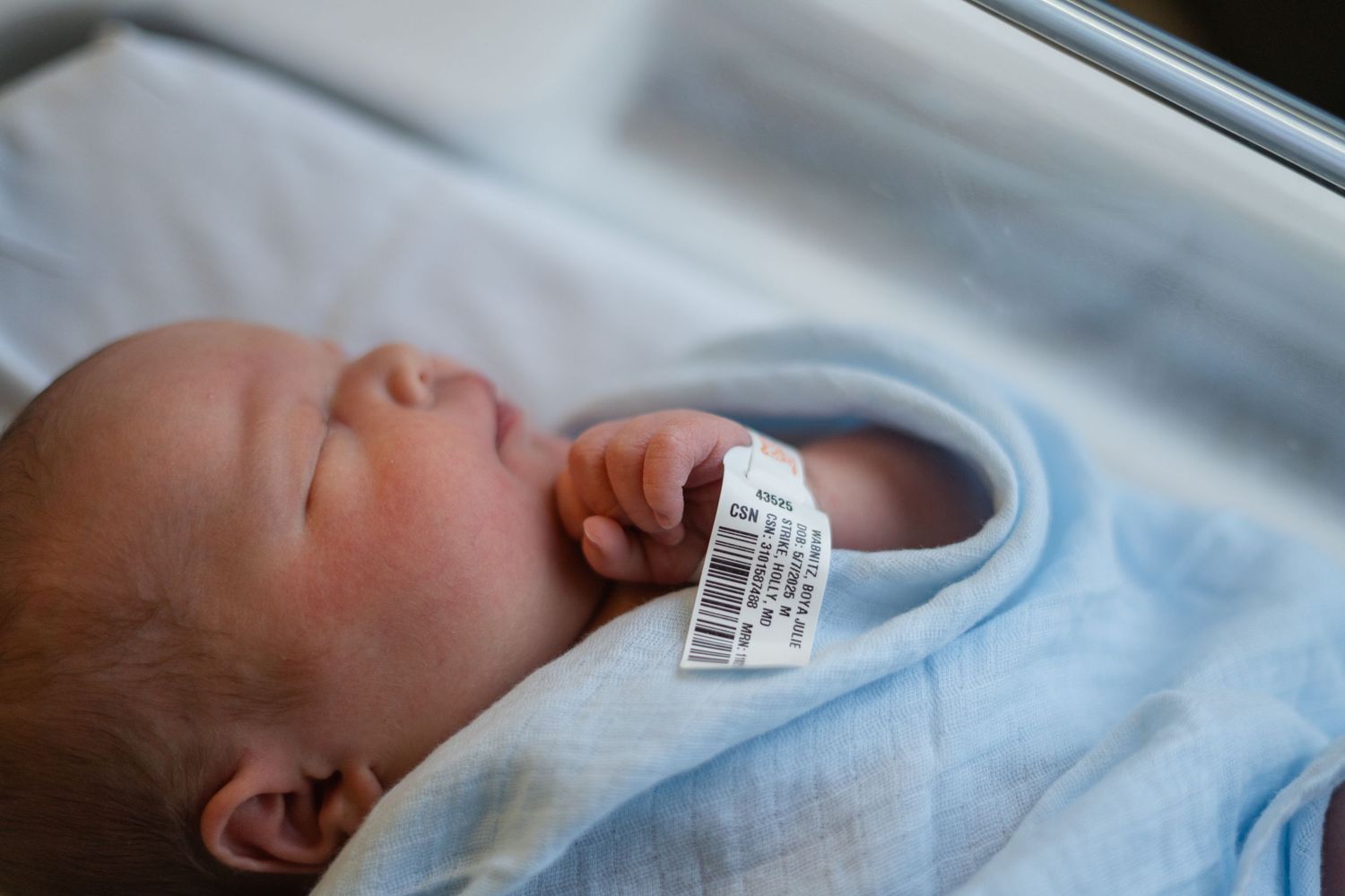 Seven sequential images show a newborn baby in a hospital environment swaddled in soft blue blankets.