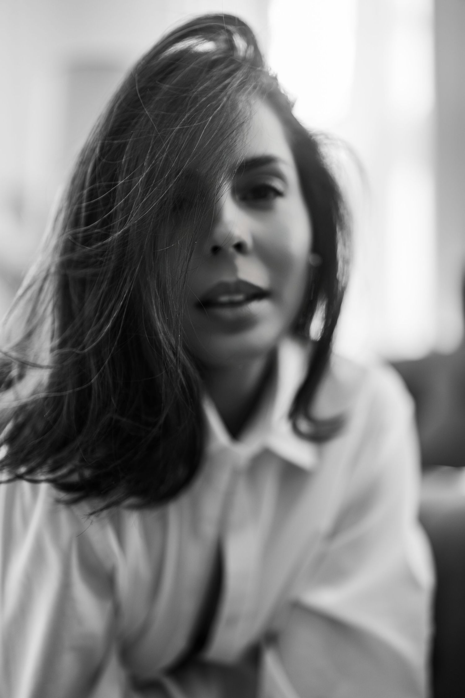 Artistic black and white photo series showing flowing dark hair in motion against a light background.