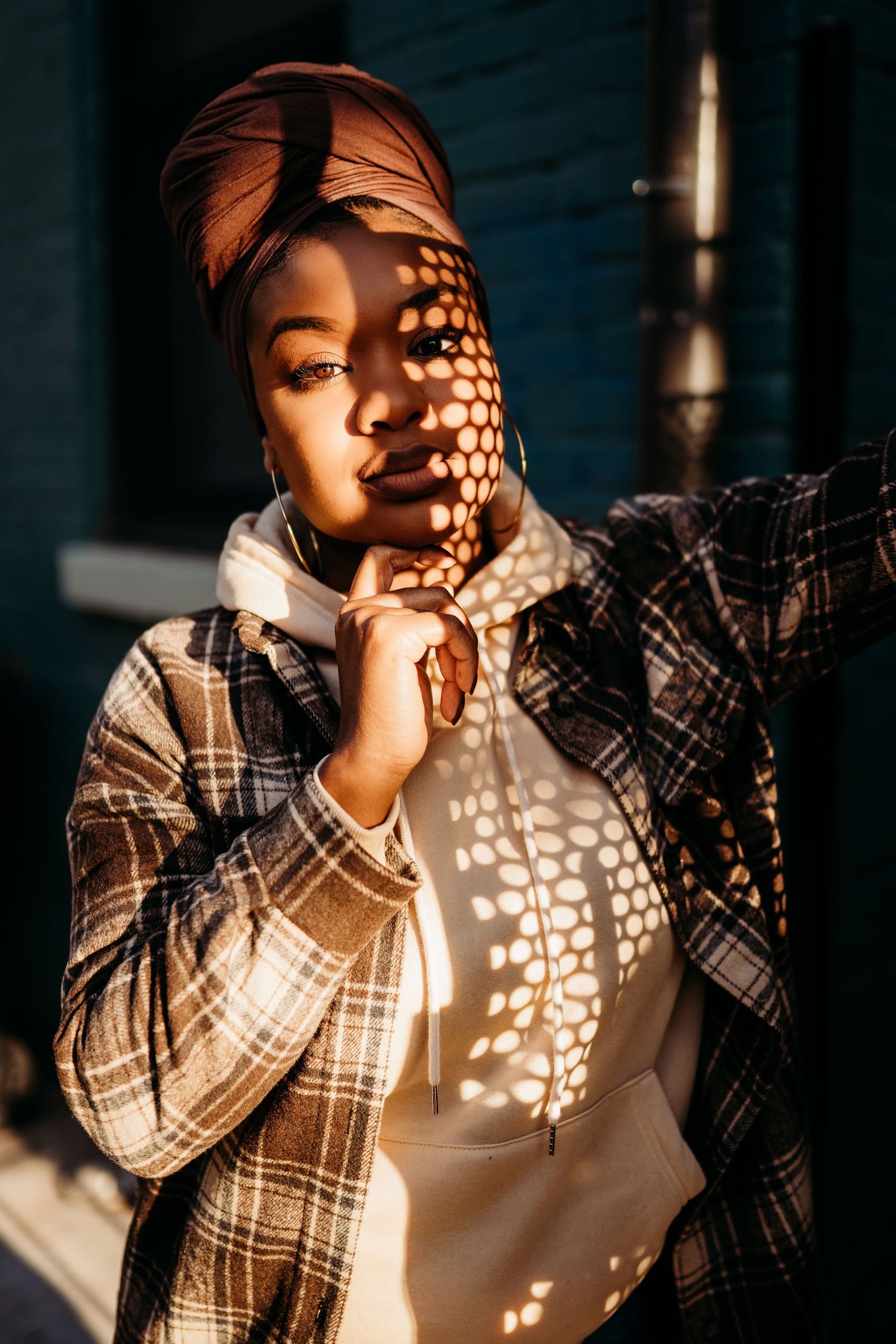 A series of artistic portraits showing sunlight casting delicate polka dot shadows through lace curtains.