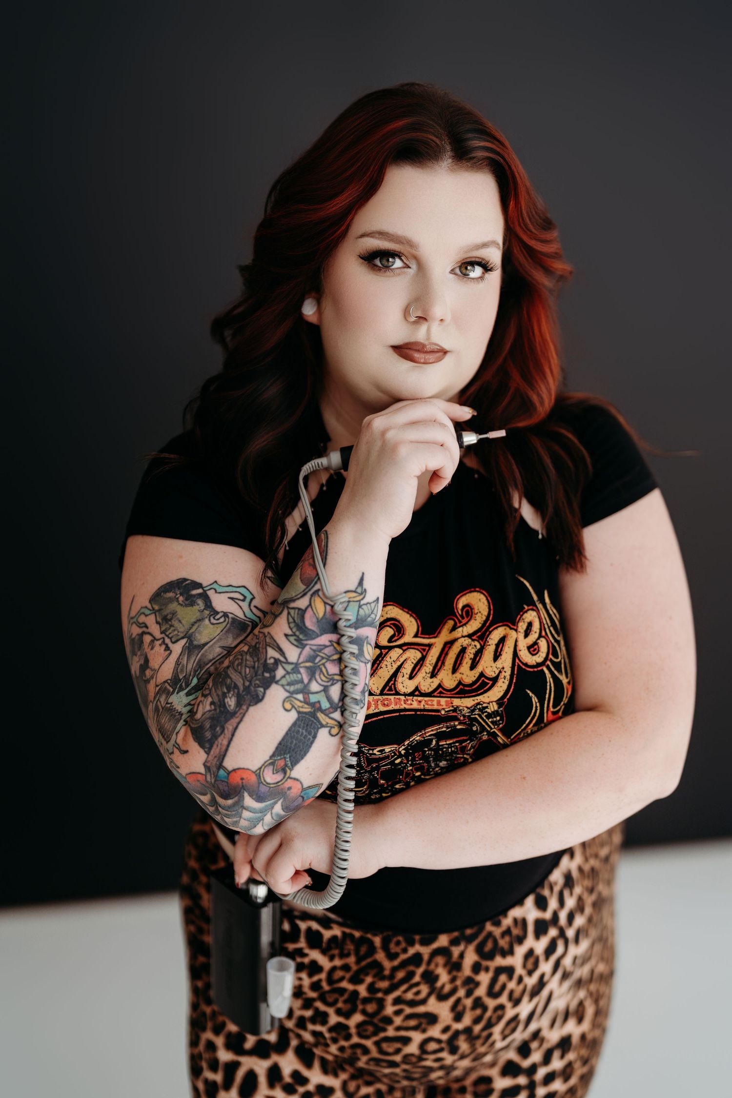 A series of moody studio portraits showing tattoo art and leopard print against a dark background.