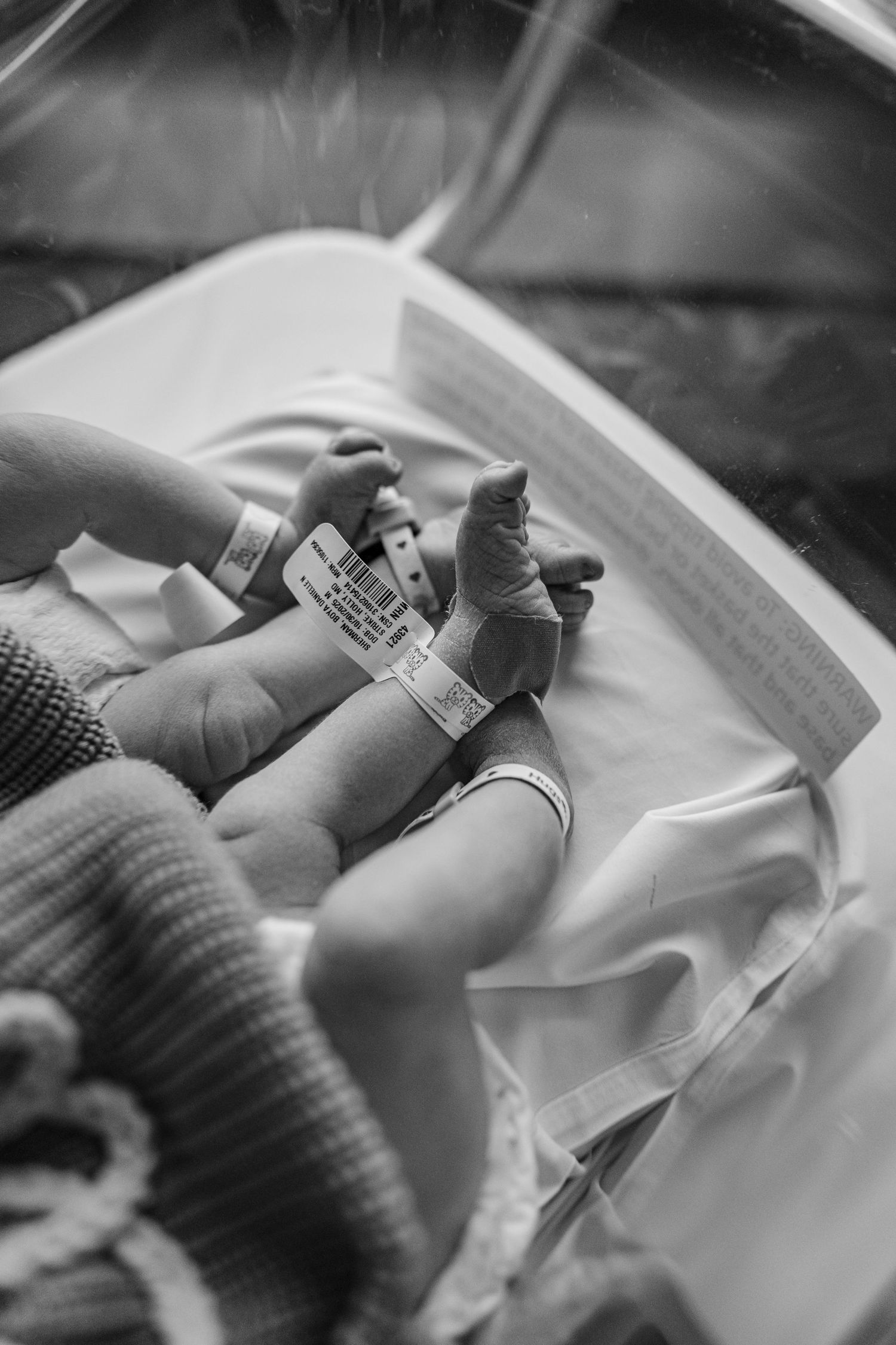 A series of black and white medical photos showing hands drawing blood or inserting an IV into a patient's arm.