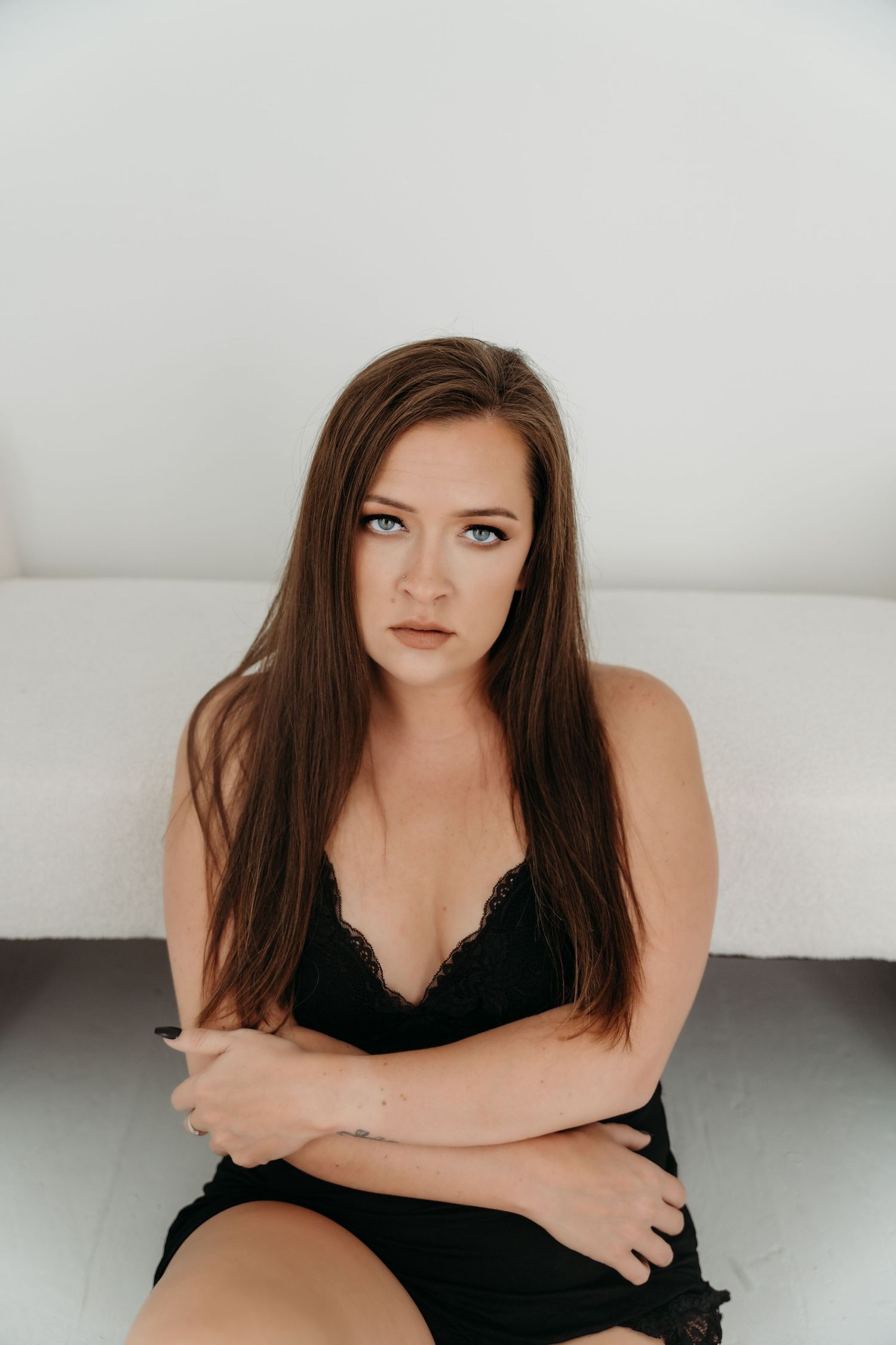 Studio portrait series in white featuring a woman in black attire.