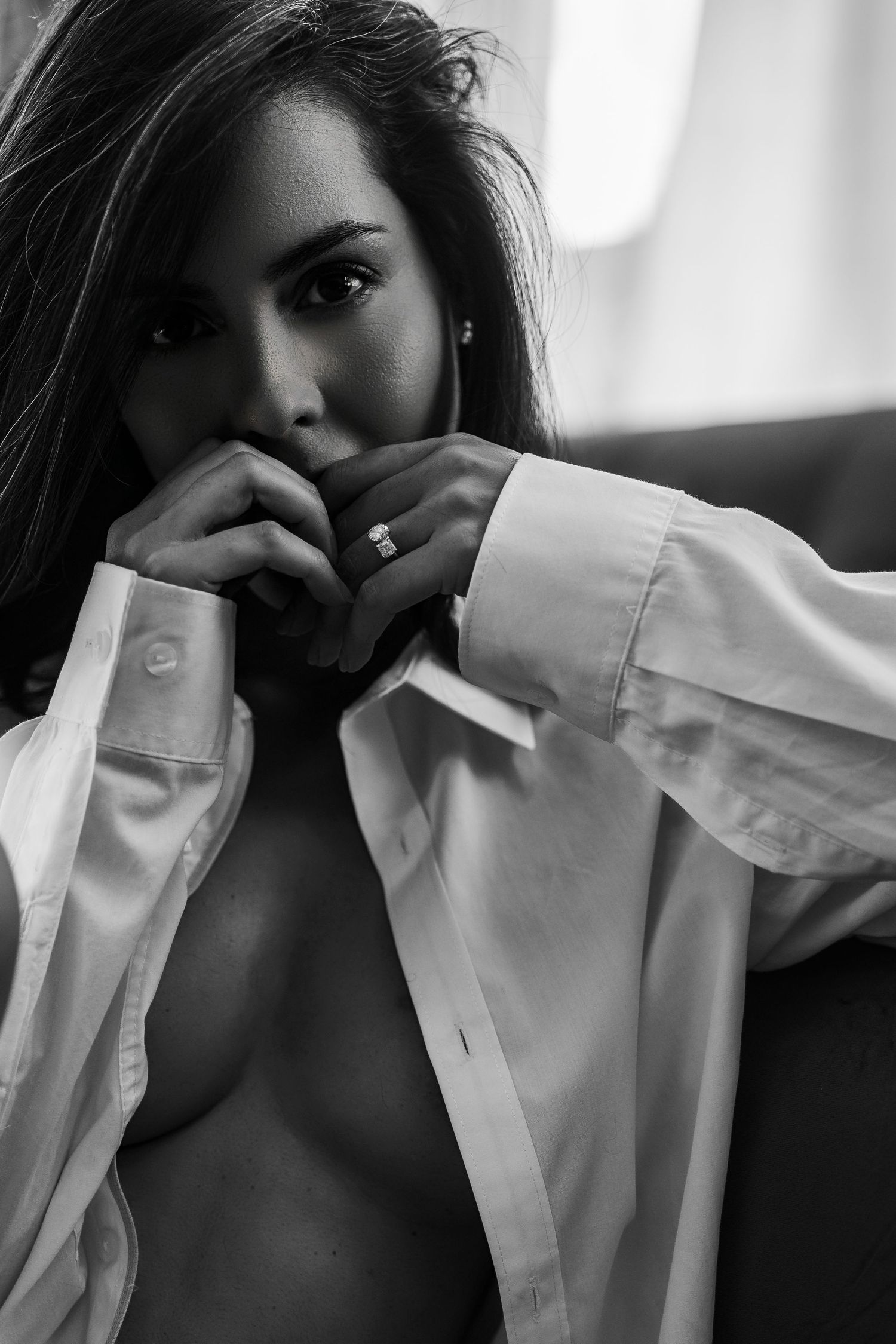 Artistic black and white portrait series showing someone in a white button-up shirt with dramatic shadows and poses.