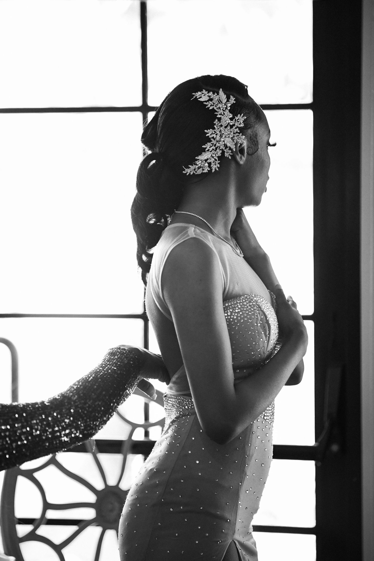 Elegant black and white silhouette of a person in a sparkly dress with a decorative hair accessory.