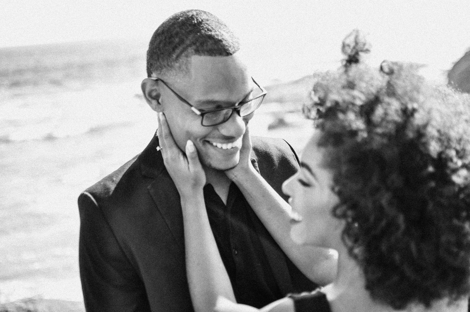 Black and white portrait of joyful couple sharing intimate moment.