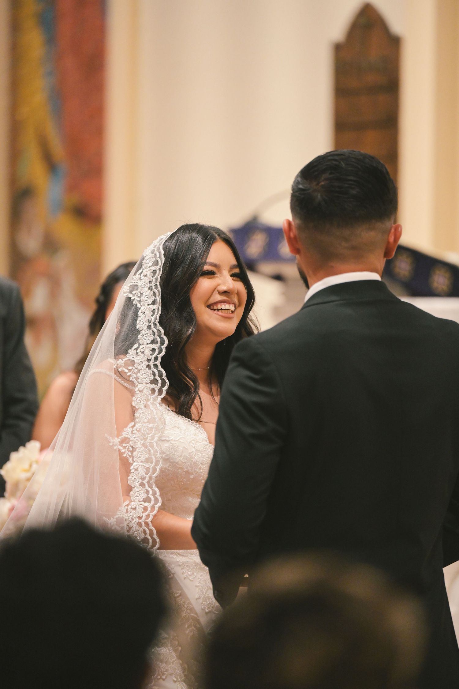 A joyful exchange between the couple during their wedding ceremony.
