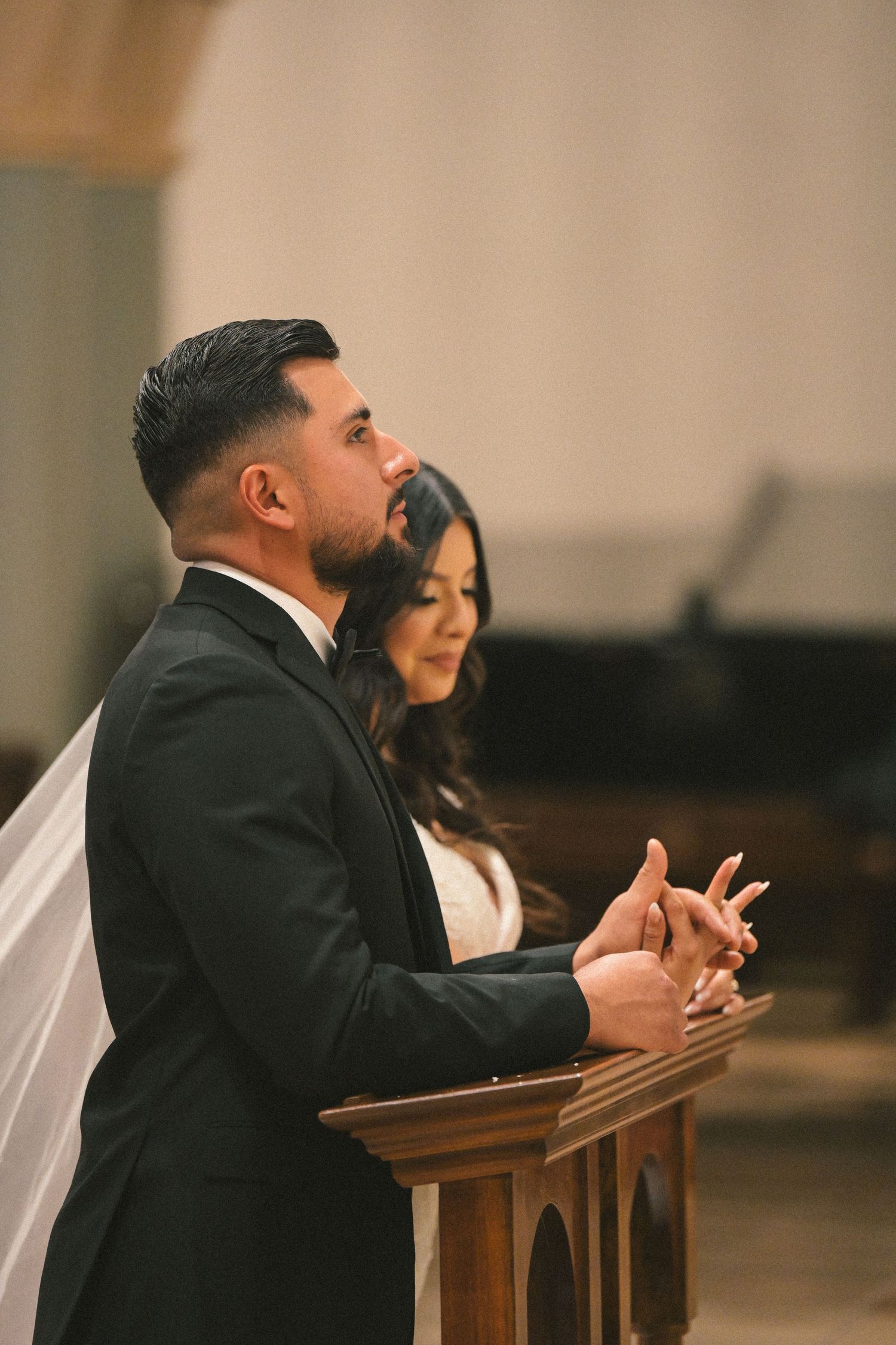 Couple standing at church altar during wedding ceremony.