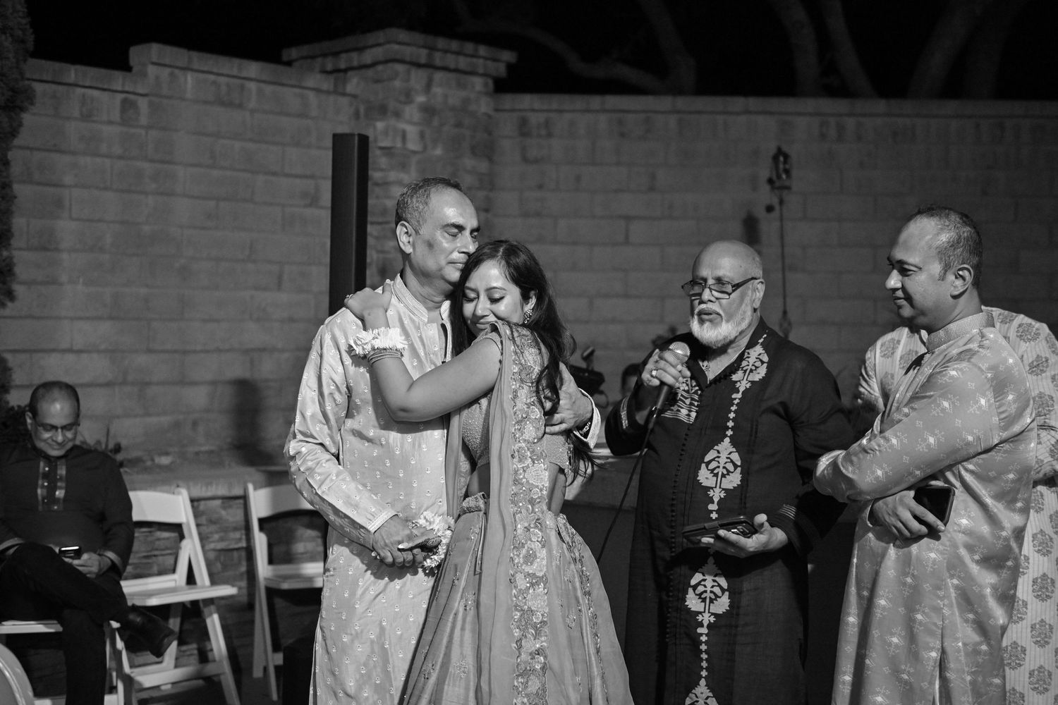 Black and white photo of wedding celebration with musicians performing outdoors.