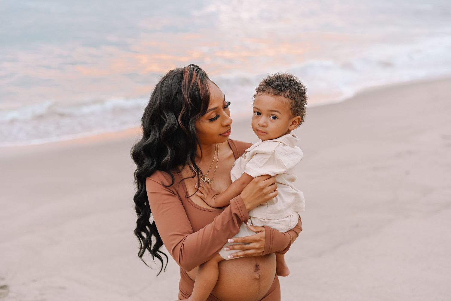 Sunset beach portrait with gentle waves and warm lighting.