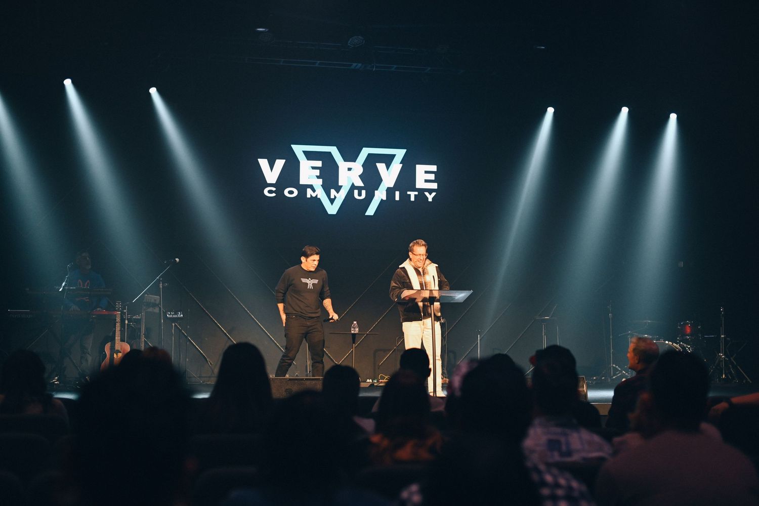 Concert performers on stage with dramatic lighting and VIVE logo display.