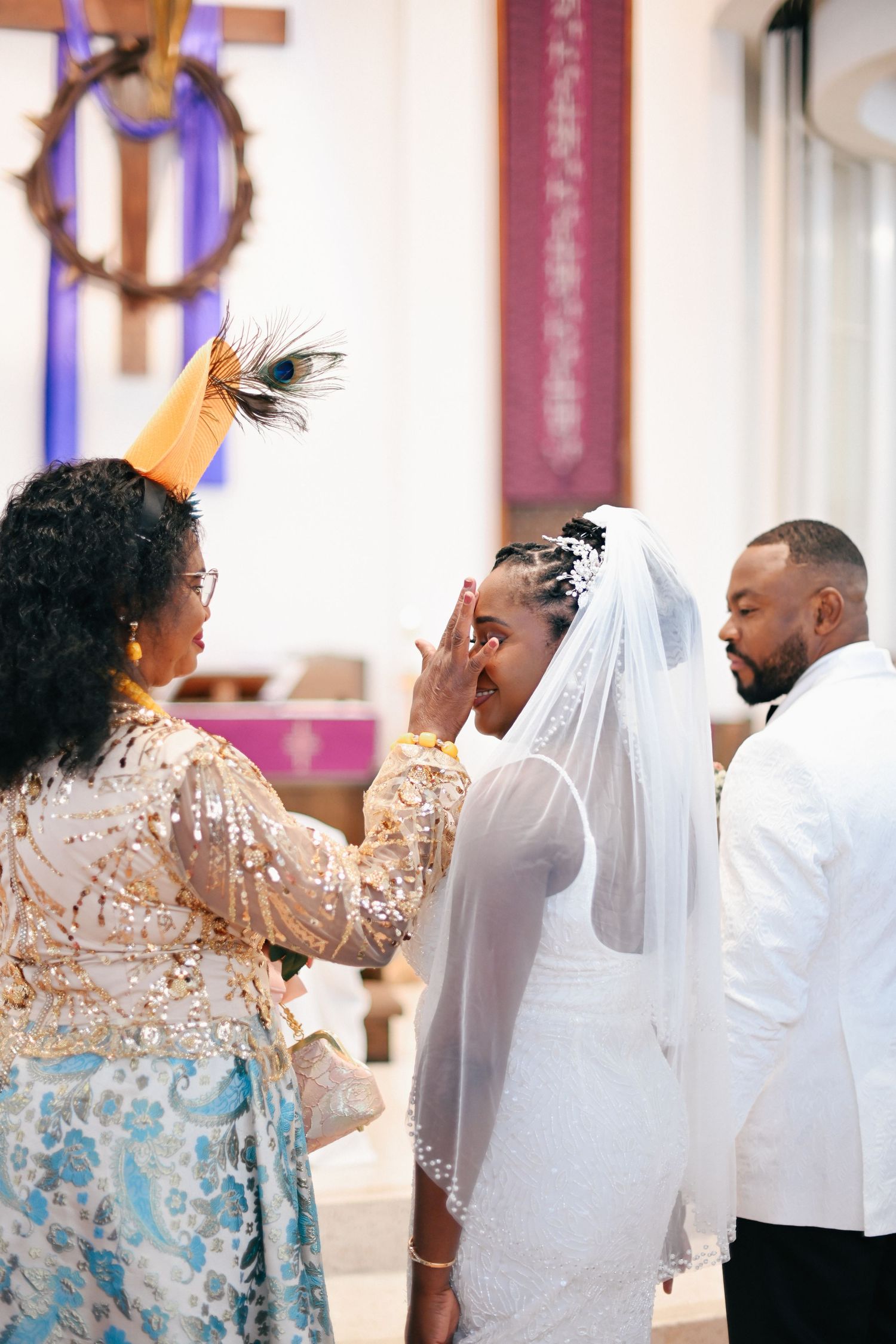 Religious blessing ceremony during wedding with officiant in sequined dress.