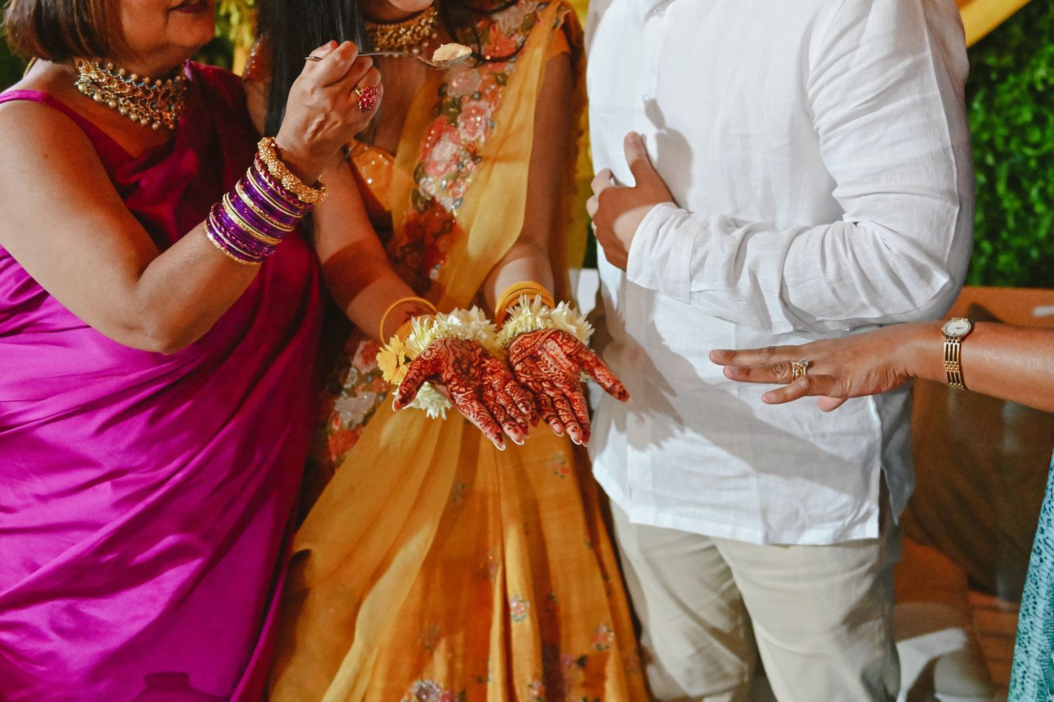 Wedding guests in vibrant attire gather during cultural celebration.
