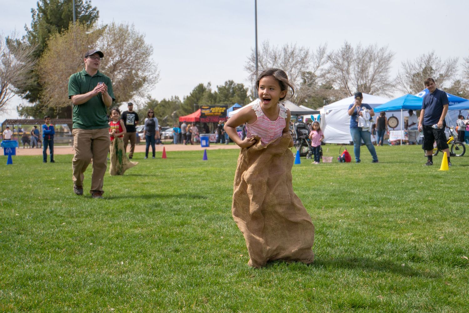 city event photography of a little girl winning a sack race