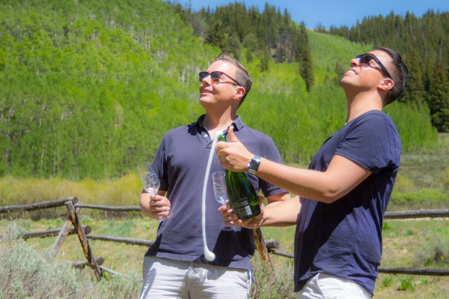 Popping champagne after he said yes to his same sex marriage proposal in Breckenridge, CO