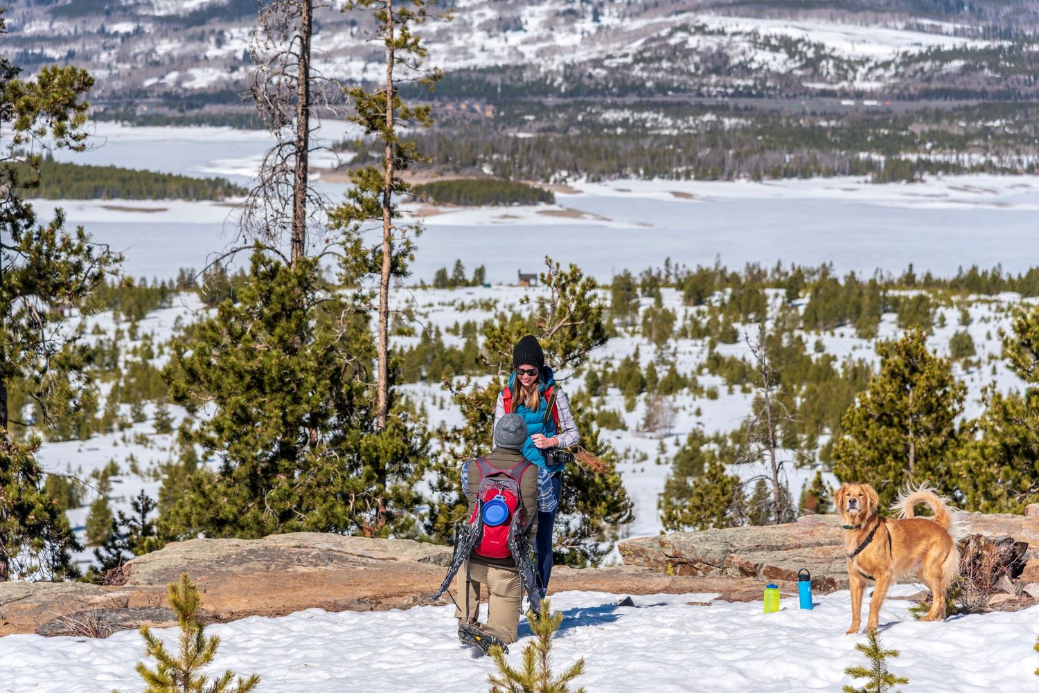 Winter surprise proposal at Prospector Point near Breckenridge, Colorado with couple and dog, captured by hidden photographer.