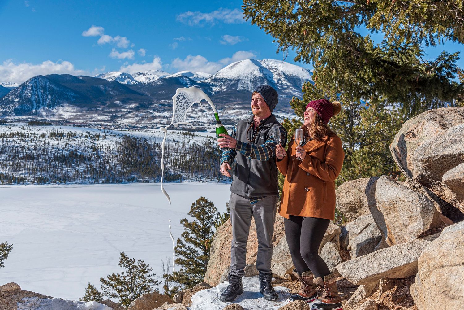 Popping champagne after she said yes to his surprise marriage proposal photographed by a professional at Sapphire Point Overlook (Colorado)