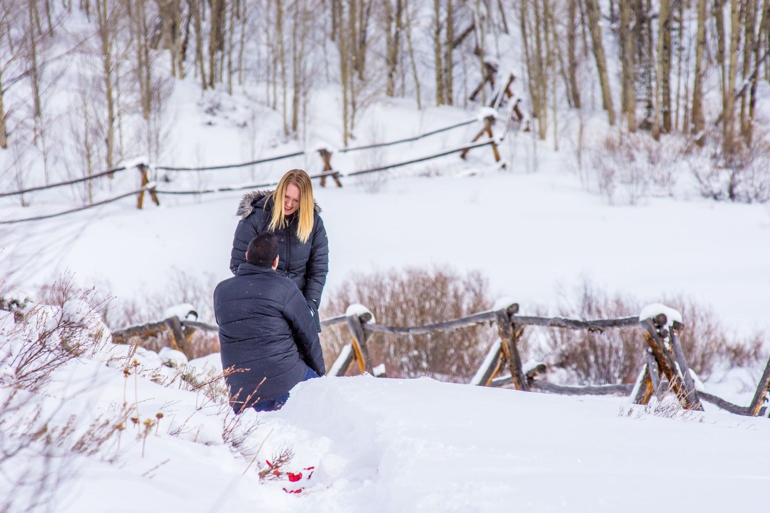 Snowy marriage proposal in Breckenridge captured by a hidden photographer along Aspen Alley