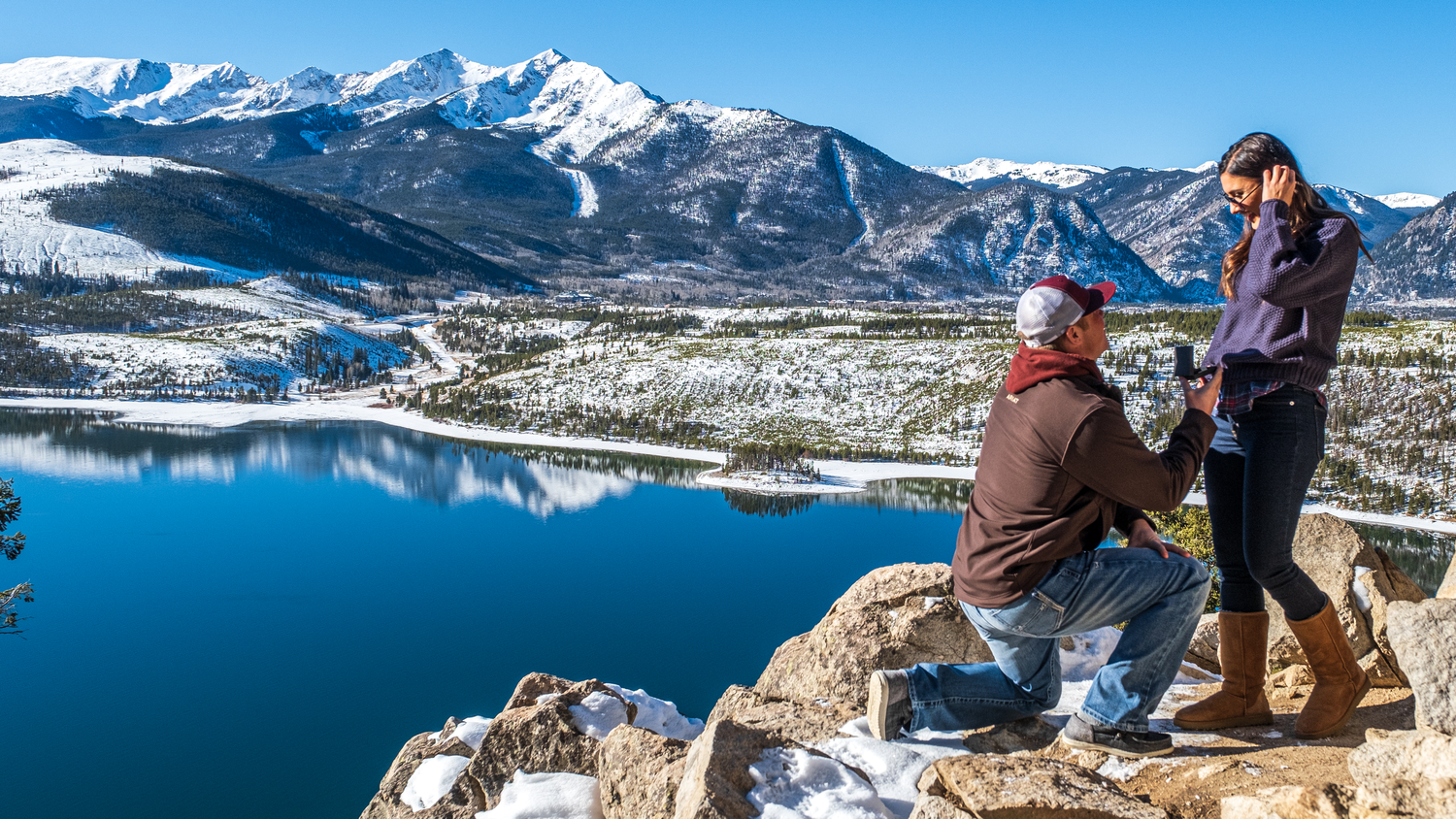 Snow-capped mountains and alpine lake reflection at Sapphire Point during this surprise marriage proposal photo session.