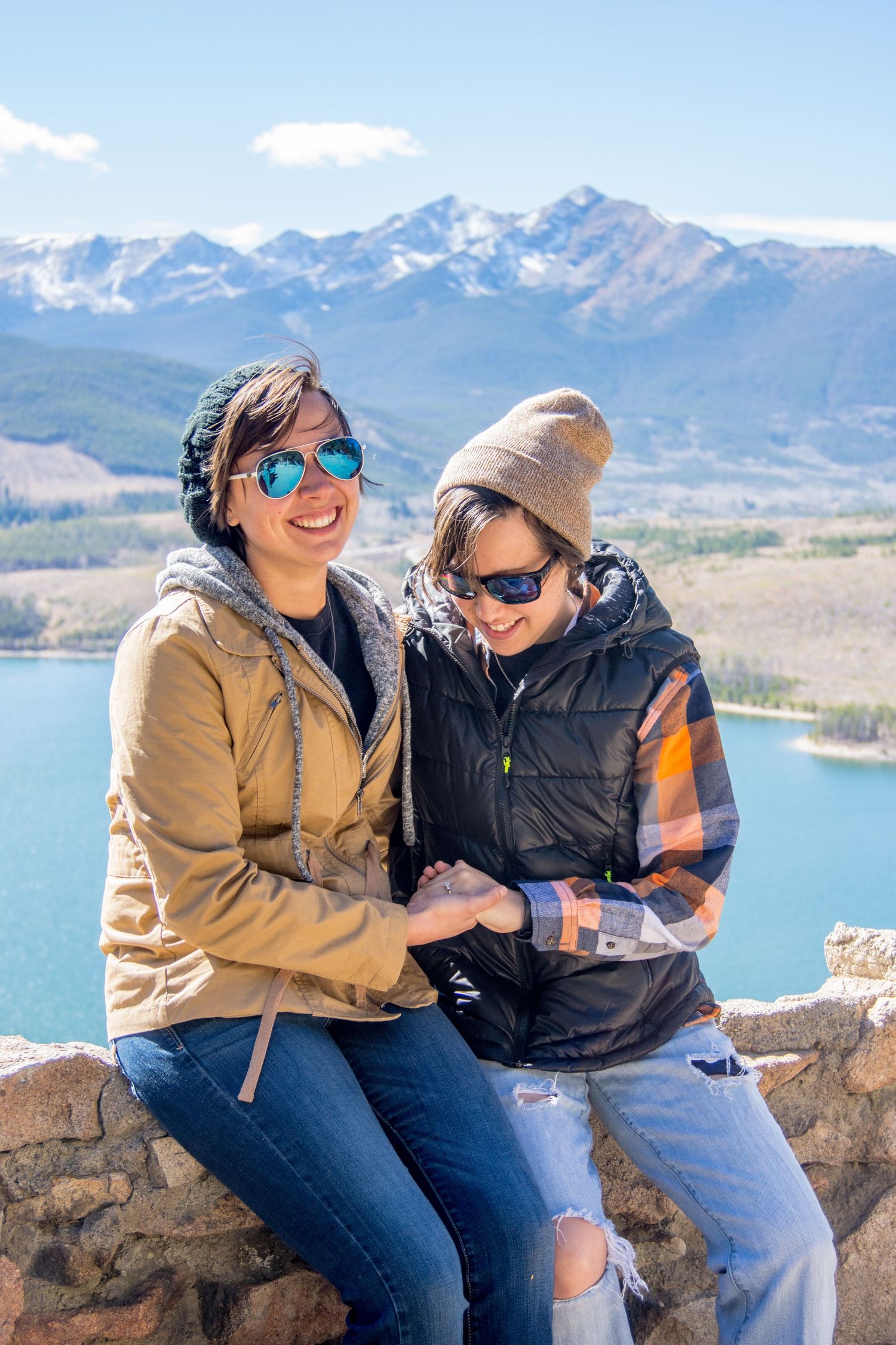 Lovely couple admiring her engagement ring at Sapphire Point Overlook near Frisco, CO after their same sex marriage proposal photography day