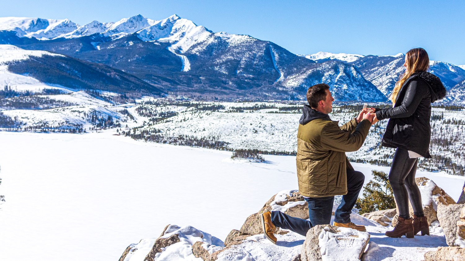 Two people during a surprise marriage proposal at Sapphire Point Overlook in Colorado captured by hidden photographer