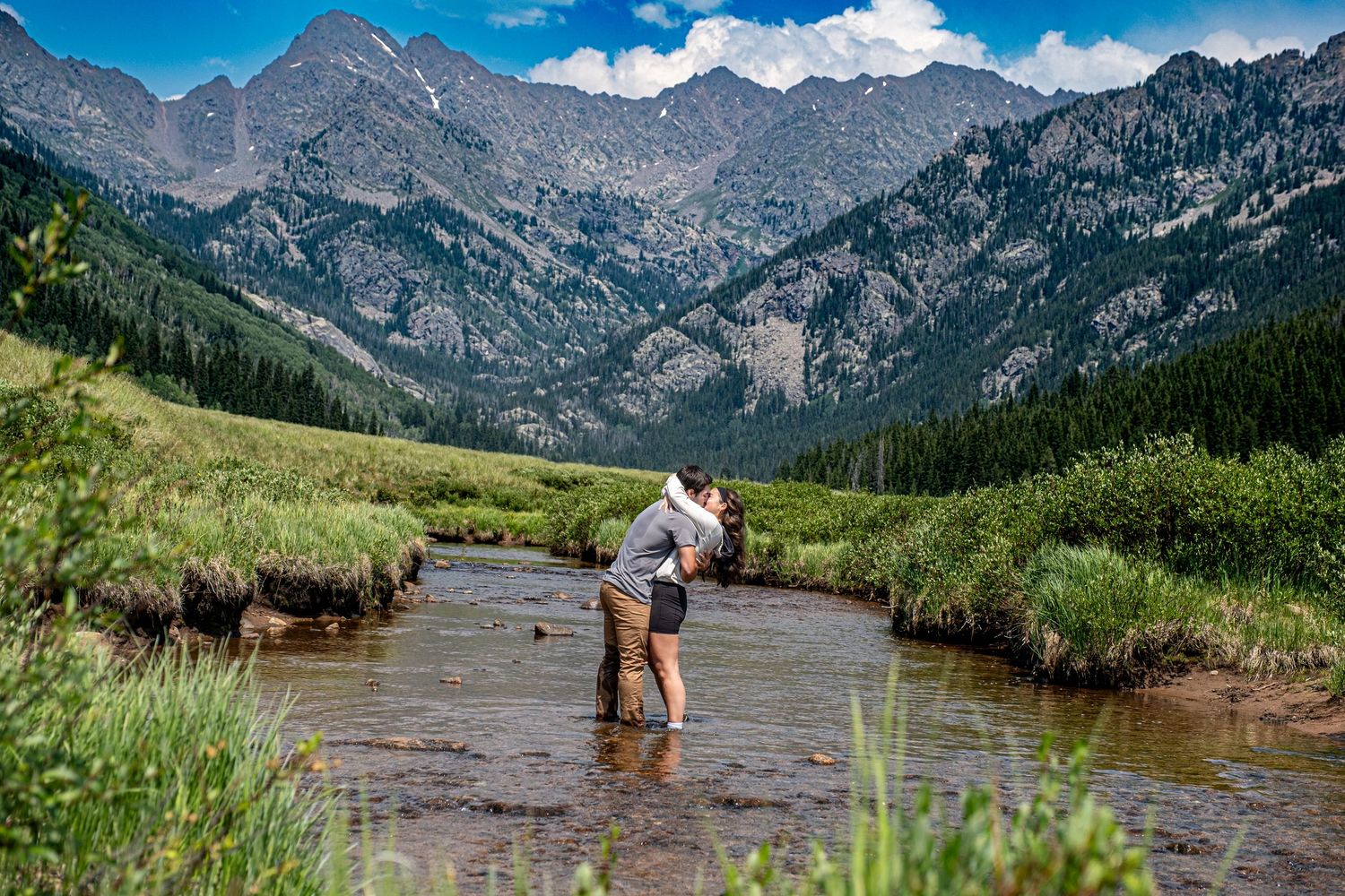 A couple embracing after she said yes to his marriage proposal near Vail, CO